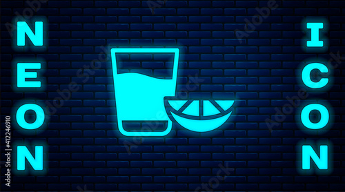 Glowing neon Tequila glass with lemon icon isolated on brick wall background. Mexican alcohol drink. Vector.