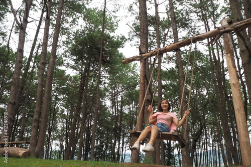 Woman and wooden swing  at Khao koh  Petchaboon  Thailand.