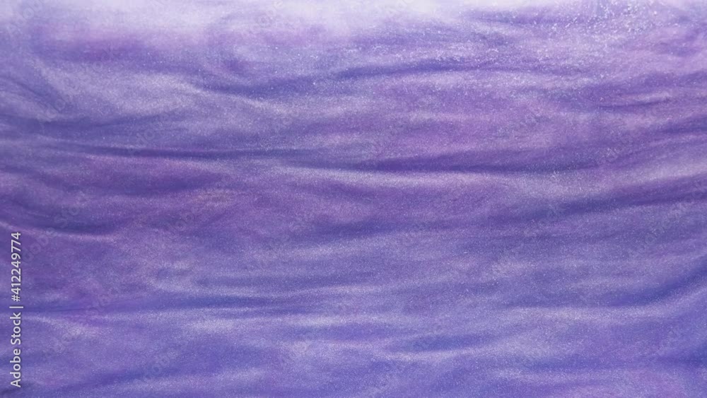 Ink flow in water. Art dynamic texture. Glitter mist motion. Purple fluid wave washing color sand grain surface abstract art background.
