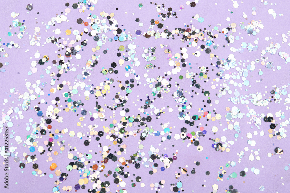 Shiny glitter on lilac background, top view