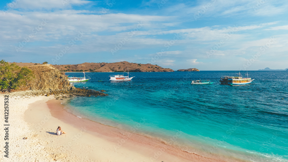 Panorama view of white sand beach in Pink Beach, Labuan Bajo, Indonesia. Sailing boat in Komodo National Park.