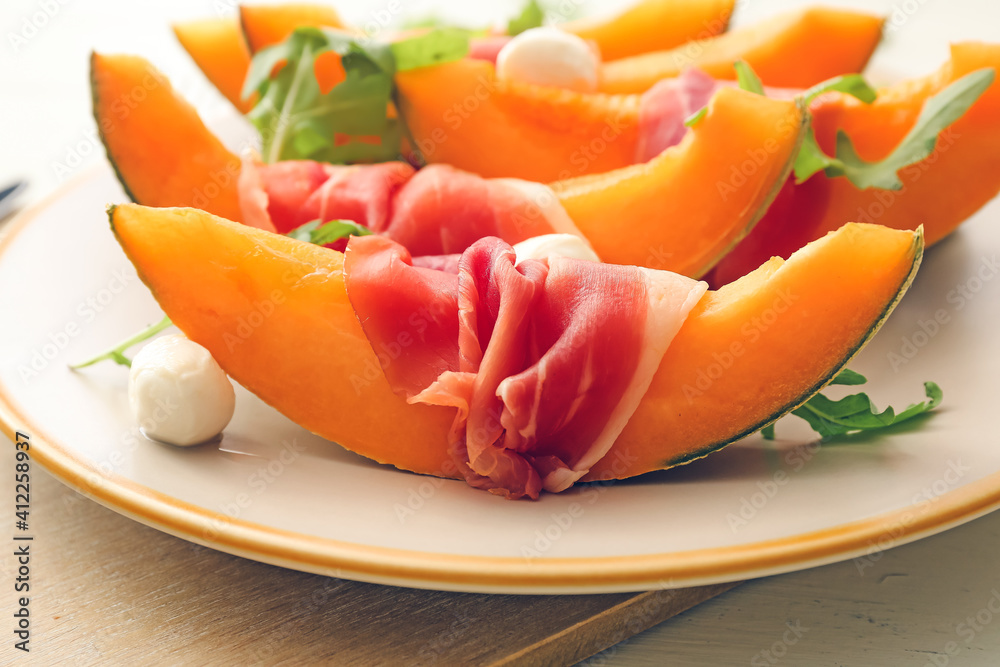 Plate with delicious melon, mozzarella and prosciutto, closeup Plate with delicious melon, mozzarella and prosciutto, closeup