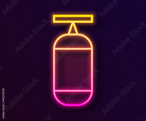 Glowing neon line Punching bag icon isolated on black background. Vector Illustration.