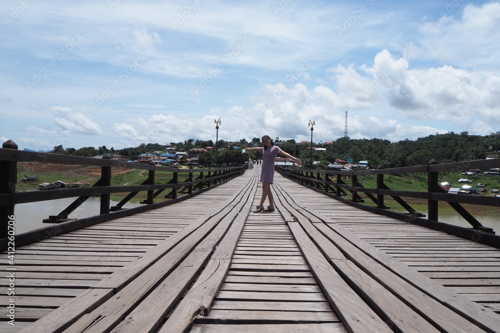 Woman on wooden bridge at Kanchanaburi, Thailand.