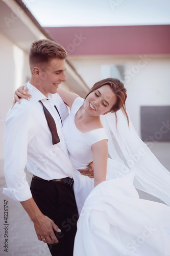 Happy bride in white dress and groom on their wedding, Bridal couple, Happy Newlywed woman and man. Loving wedding couple. in a light interior 