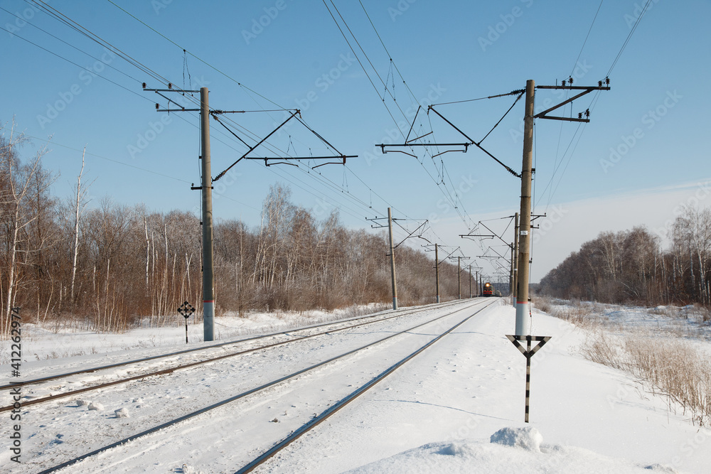 winter train in Dali leaves the forest, railway power line winter train in Dali leaves the forest, railway power line