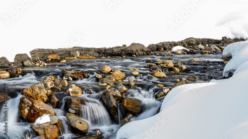 a mountain creek in the spring with water of melting snow, long exposure water photography