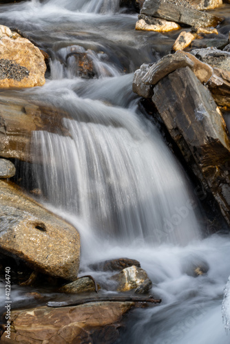 a mountain creek in the spring with water of melting snow  long exposure water photography