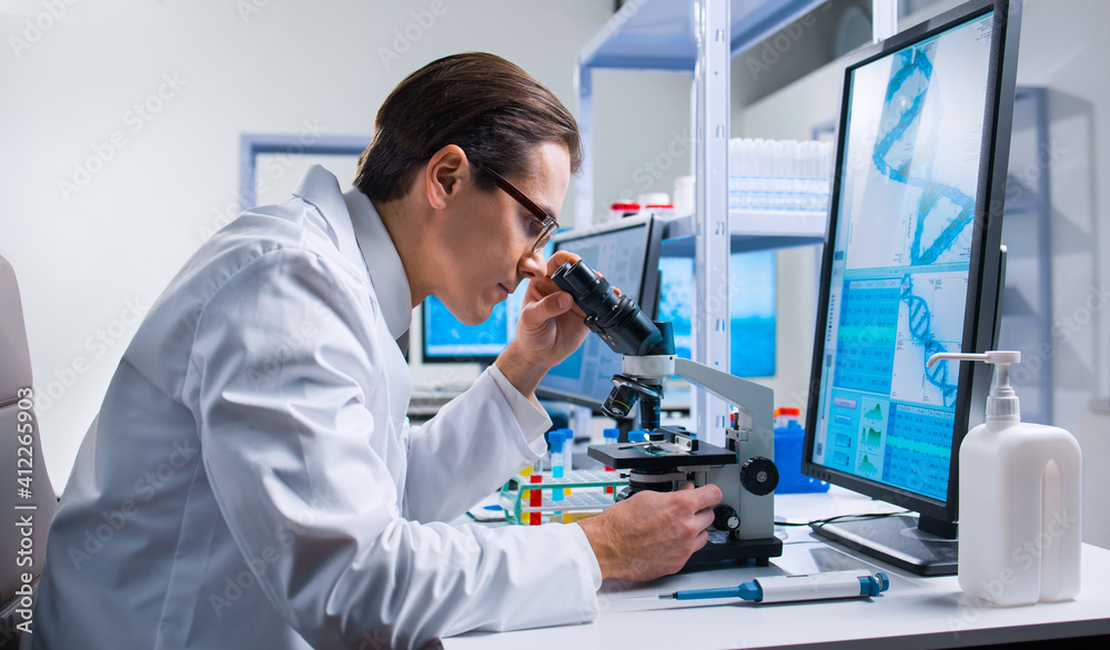 Professional scientist is working on a vaccine in a modern scientific research laboratory. Genetic engineer workplace. Future technology and science. Professional scientist is working on a vaccine in a modern scientific research laboratory. Genetic engineer workplace. Future technology and science.