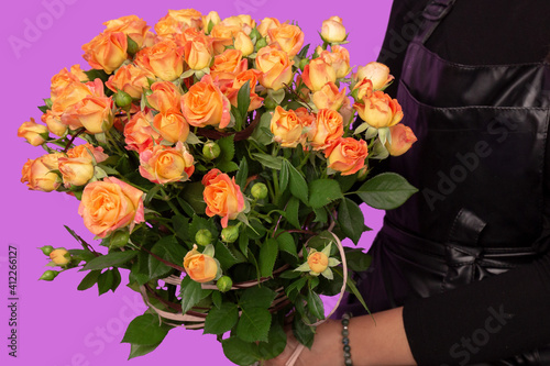 The girl with big bouquet of orange tea roses