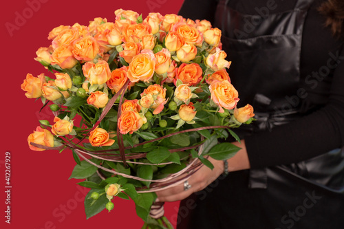 The girl with big bouquet of orange tea roses
