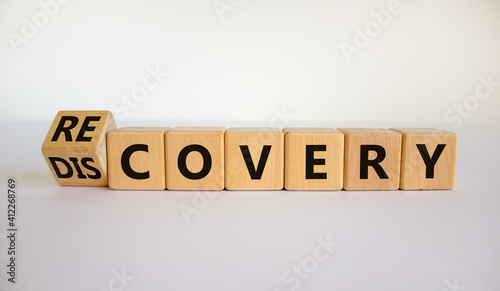 Recovery or discovery symbol. Turned a wooden cube, changed a word 'discovery' to 'recovery'. Beautiful white background. Business and discovery or recovery concept. Copy space.
