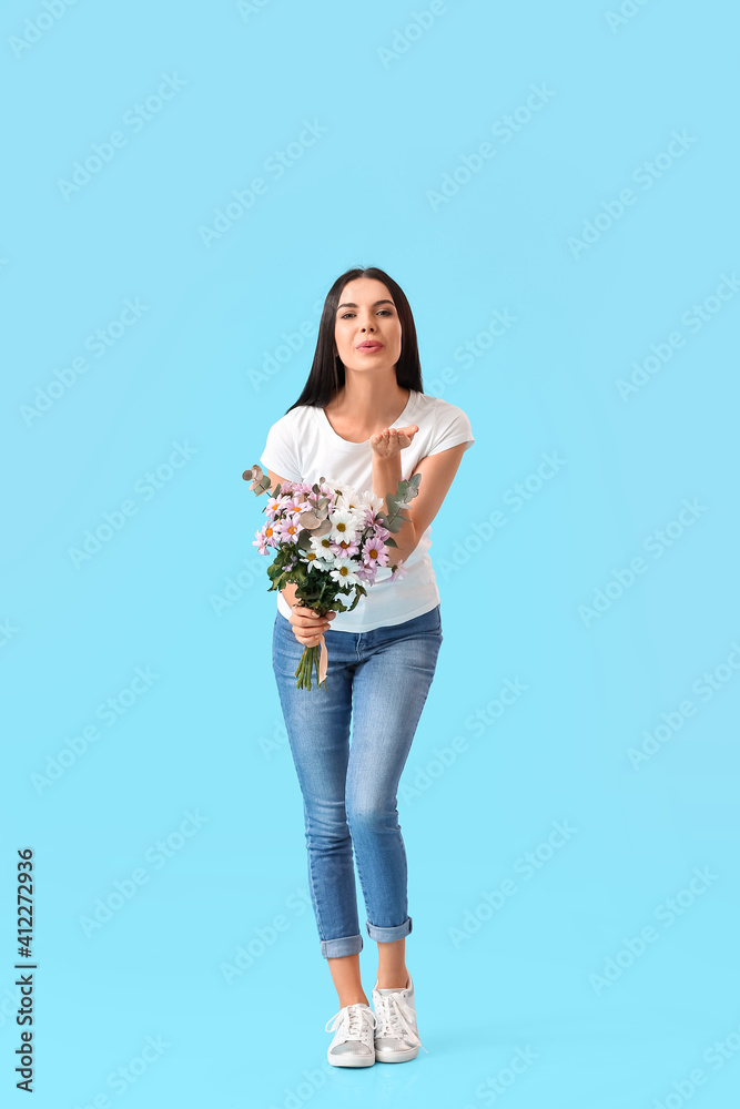 Beautiful woman with flowers blowing kiss on color background. International Women's Day celebration Beautiful woman with flowers blowing kiss on color background. International Women's Day celebration