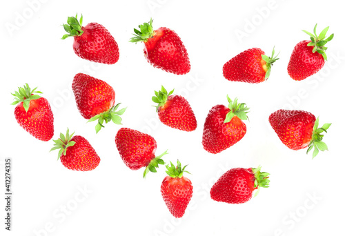 Falling strawberries on white background