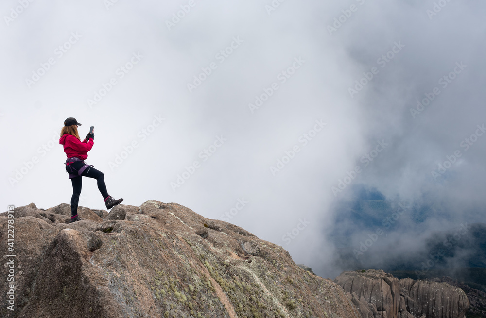 woman making a selfie on top of mountain woman making a selfie on top of mountain