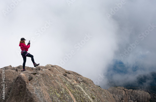 woman making a selfie on top of mountain