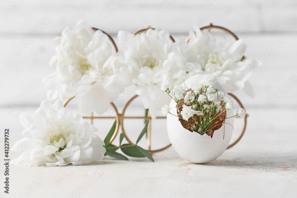 Fototapeta premium Creative composition with Easter egg and flowers on table