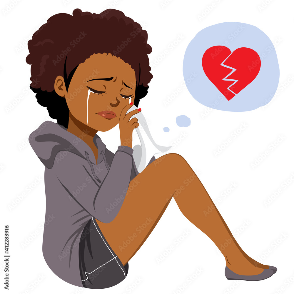 Young Black woman crying drying her tears with white paper sitting on floor with heartbroken
