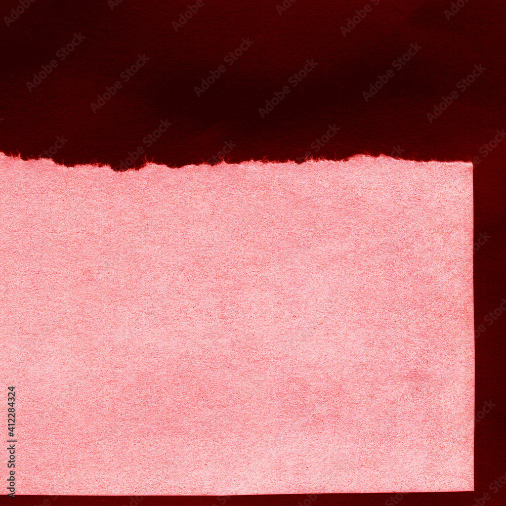 Fototapeta premium Red and brown torn paper collage close-up. Texture made from various paper and cardboard parts. Damaged old paper background. Vintage blank wallpaper. Material design backdrop.