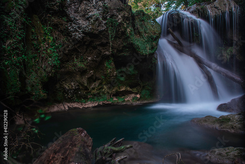 Waterfall in the forest. Carpathian Mountains. Clean water. Mossy rocks. La Vaioaga, Banat, Romania.