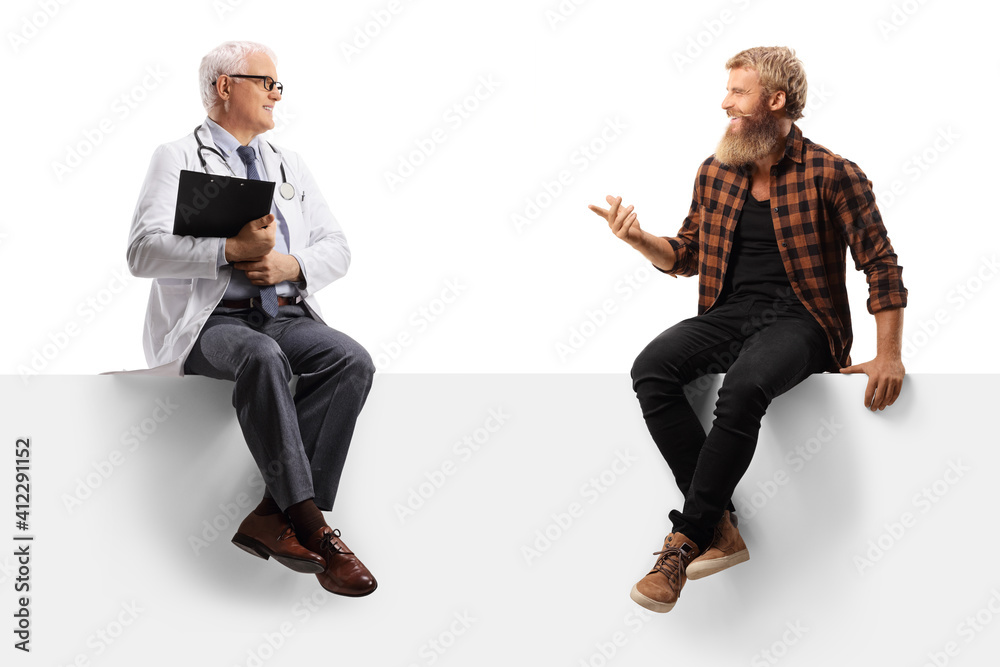 Full length shot of a mature doctor sitting on a blank panel with a bearded guy patient and talking Full length shot of a mature doctor sitting on a blank panel with a bearded guy patient and talking