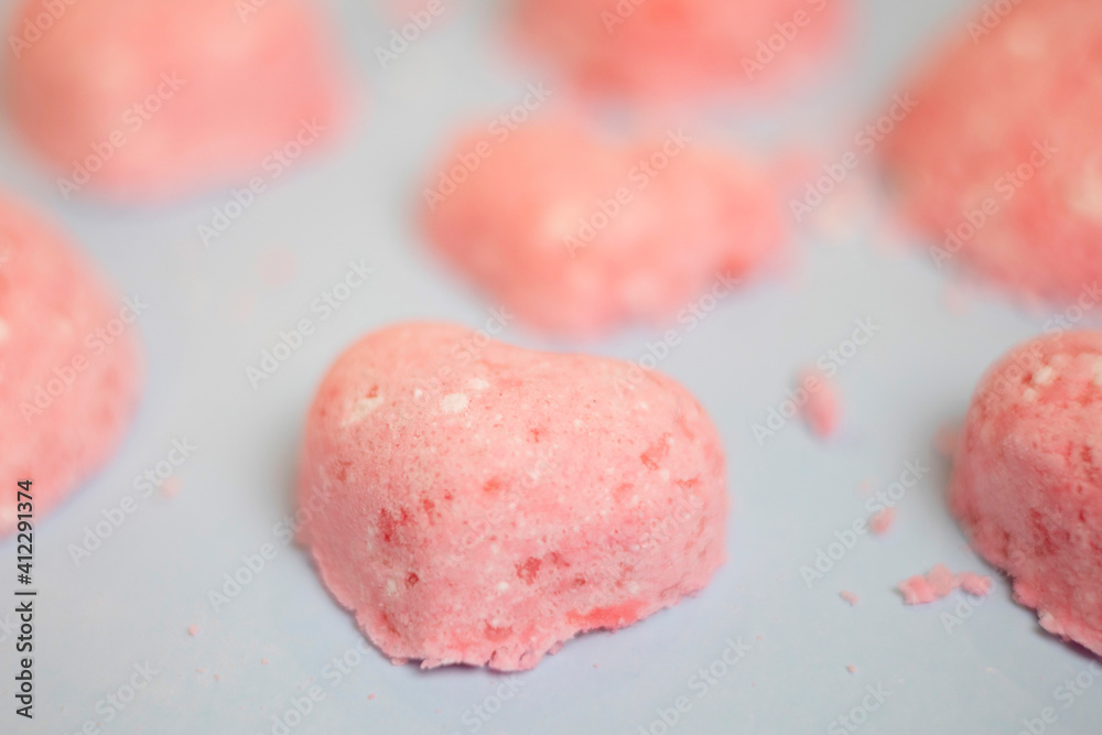 selective focus of a bath bomb from sea salt, citric acid, soda, dye and flavor on a blue background selective focus of a bath bomb from sea salt, citric acid, soda, dye and flavor on a blue background