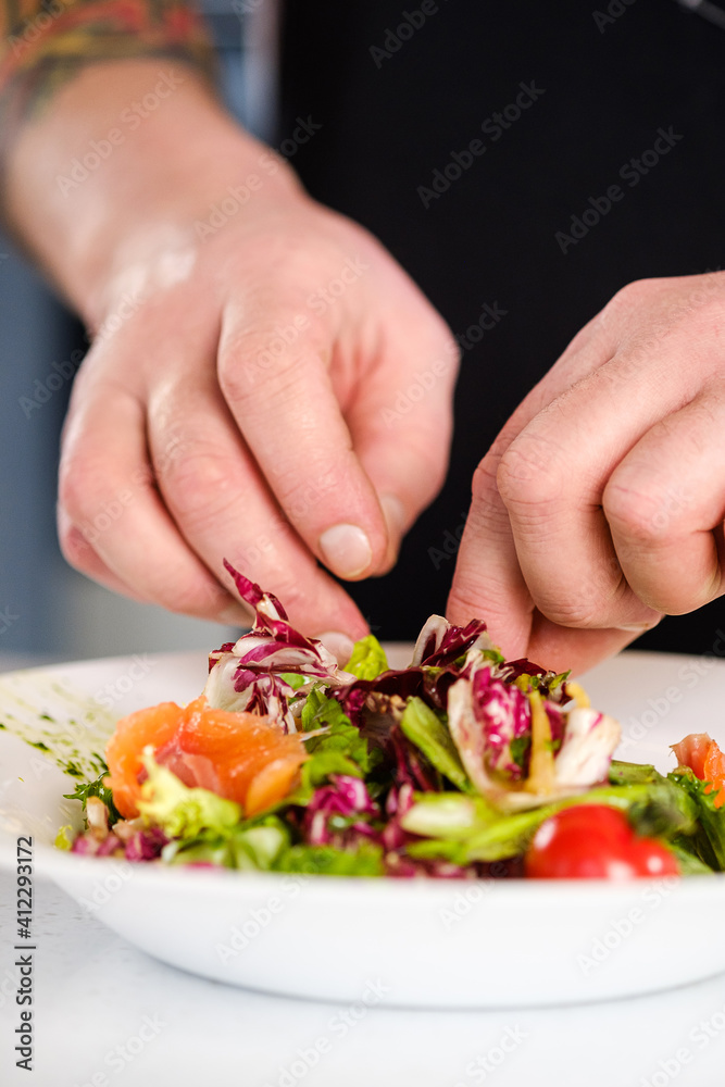 The chef makes a ready-made salad dish.