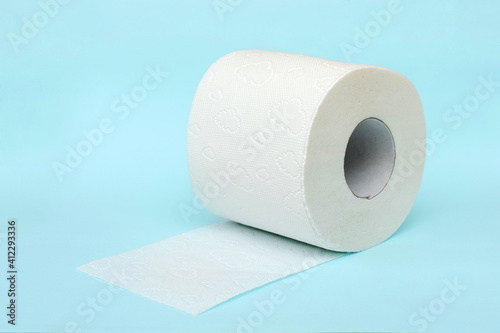 Roll of white toilet paper on blue background