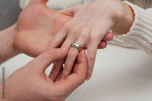 The man proposes. The husband puts the ring on his wife's finger. Valentine's Day