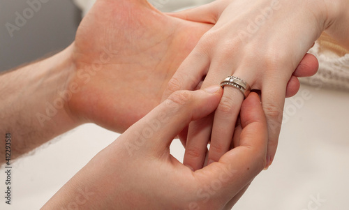 The man proposes. The husband puts the ring on his wife's finger. Valentine's Day