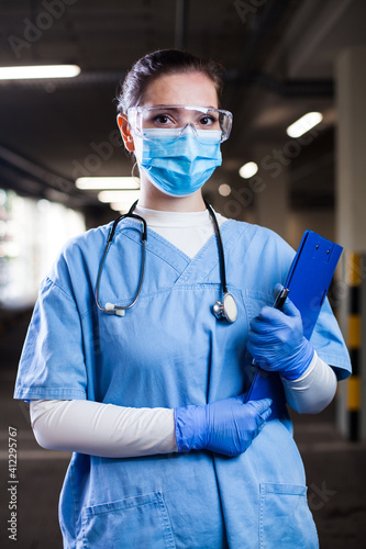 Portrait of young pretty female doctor wearing blue uniform