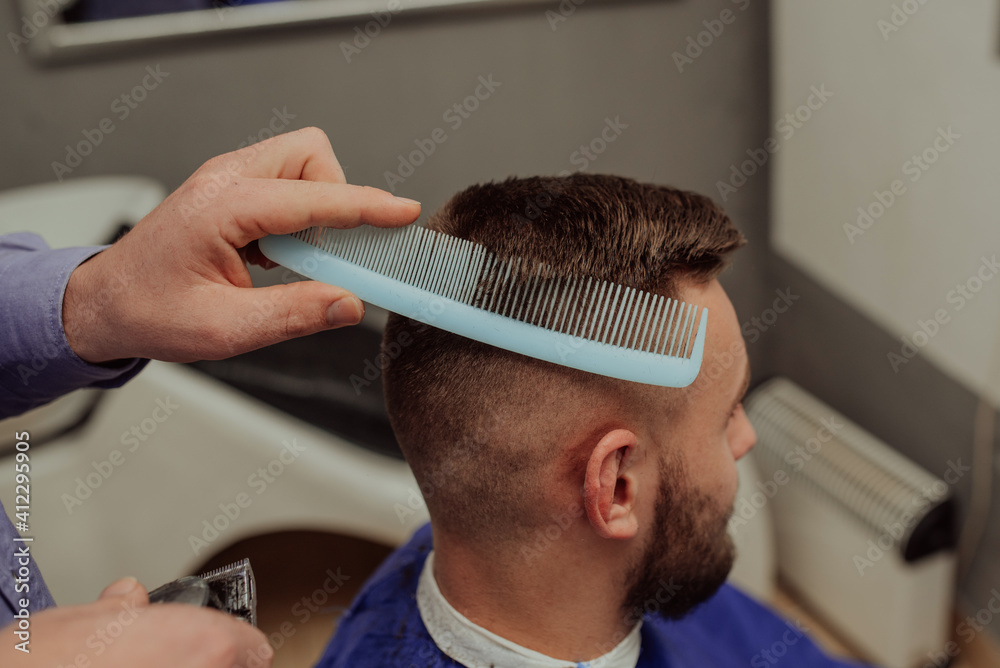 Fototapeta premium Young Man in Barbershop Hair Care Service ConceptYoung Man in Barbershop Hair Care Service Concept