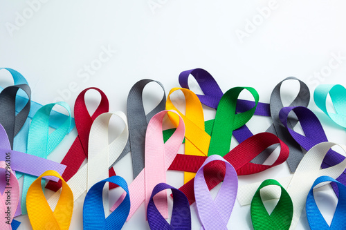 Multi colored cancer ribbon background. Proudly worn by patients, supporters and survivors for world cancer day. Bringing awareness to all types of cancer with copy space
