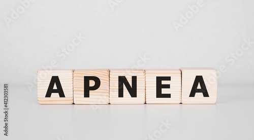 Word APNEA written on wood block. Business concept