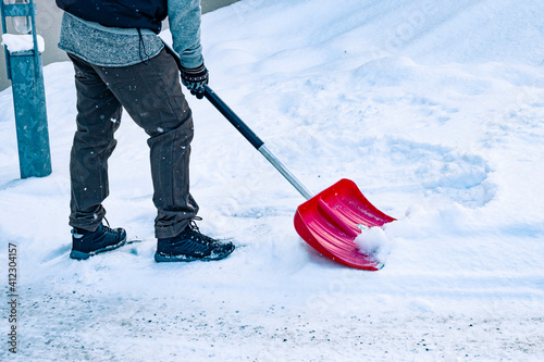 Photography Man shoveling snow outside in the winter