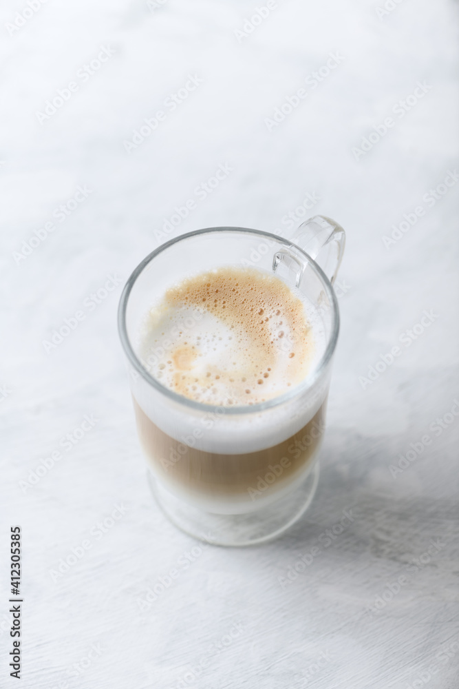 Coffee with milk on bright wooden background. Close up. Copy space. Coffee with milk on bright wooden background. Close up. Copy space.