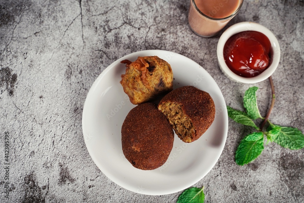 Homemade Beef Cutlets - Kerala snacks served with tea, selective focus Homemade Beef Cutlets - Kerala snacks served with tea, selective focus