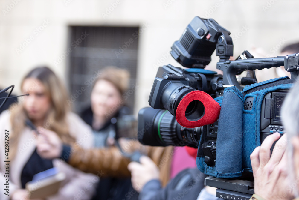Filming media event or news conference with a video camera. Public relations - PR concept. Filming media event or news conference with a video camera. Public relations - PR concept.