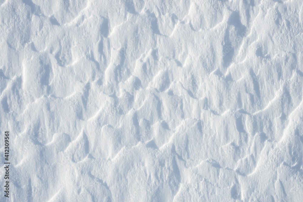 Fototapeta premium Fresh clean white snow background texture. Winter background with frozen snowflakes and snow mounds. Snow lumps. Seasonal landscape details. Cold weather.