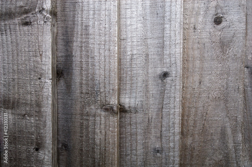Washed out grey wooden fence planks close up, background