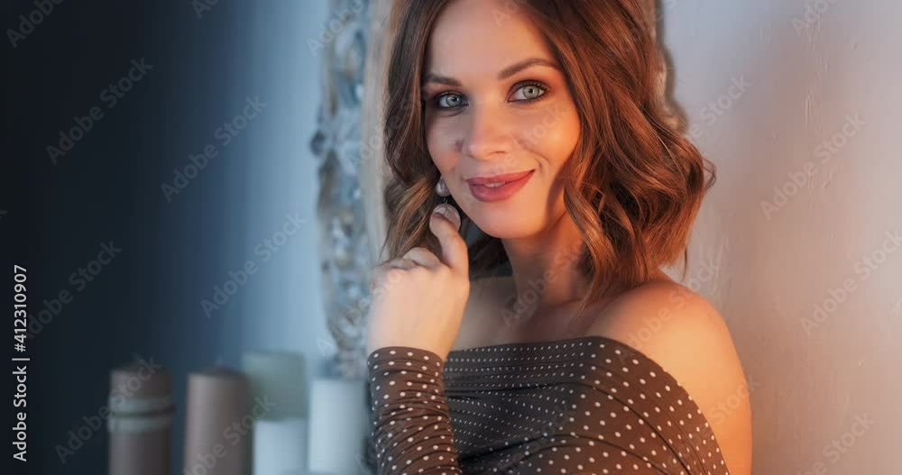 Blonde woman's portrait. Young caucasian blonde woman looks at the camera and smiles