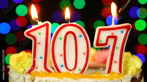 Number 107 Happy Birthday Cake With Burning Candles Topper. photo