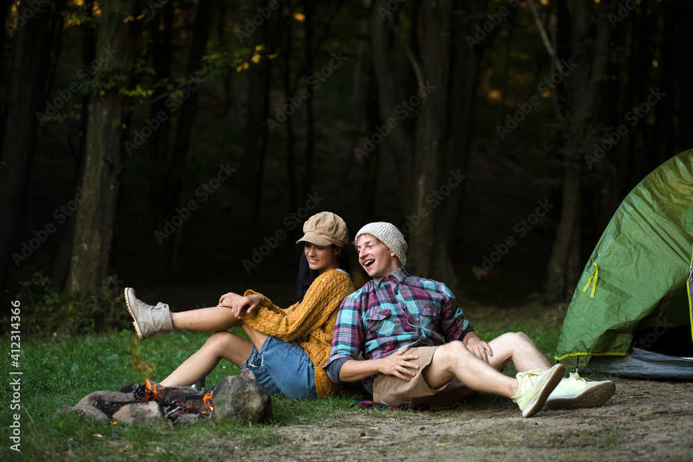 Shot of a happy couple camping on the nature. Couple in love. Love story. 