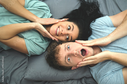 Morning of happy young couple in bed. Sexy couple. Emotion. 