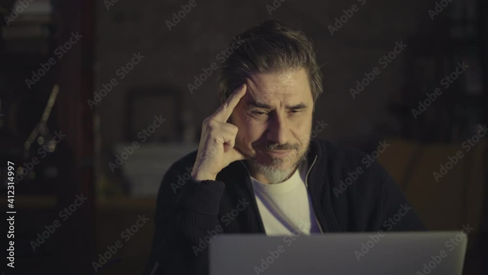 Older man working online with laptop computer at home sitting at desk. Home office, browsing internet, study room. Older man working online with laptop computer at home sitting at desk. Home office, browsing internet, study room.