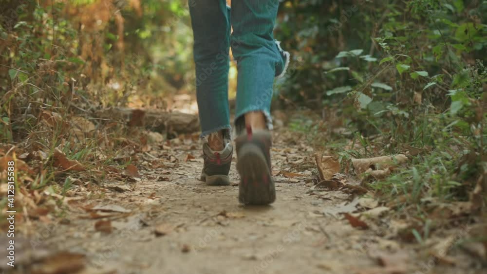 Close up of woman legs is trekking and enjoying in the woods, holidays and traveling concept. Close up of woman legs is trekking and enjoying in the woods, holidays and traveling concept.