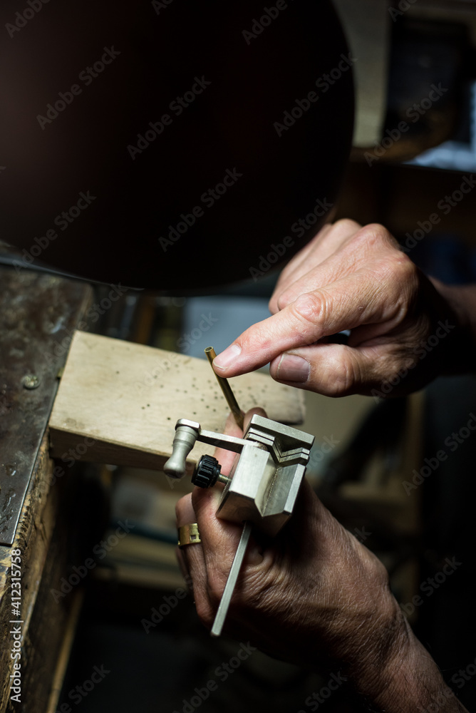 Jeweler making a necklace on his wokshop Jeweler making a necklace on his wokshop