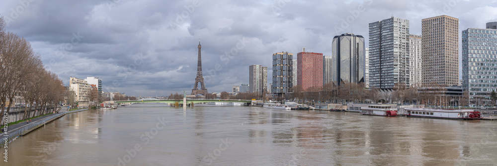 Paris, France - 02 05 2021: Panoramic view of the Seine during flood with the Statue of Liberty Paris, Grenelle Bridge the Eiffel Tower and  Grenelle district