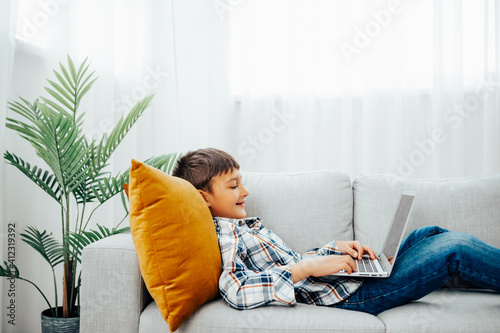 Photography Child blogging in internet, concentrated boy and girl with laptop at home