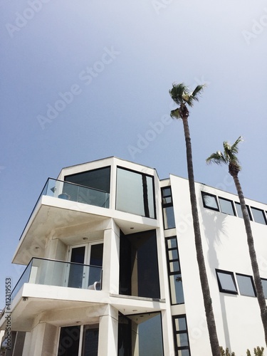 exterior of modern white house with palm trees